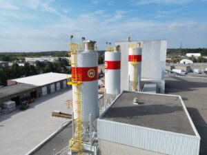 Aerial view of Richvale York Block white silos with red bands and yellow safety ladders.