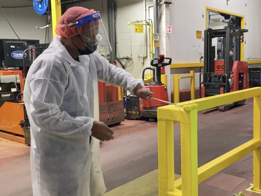 BEST Painting inspector checking coating on a food plant guardrail