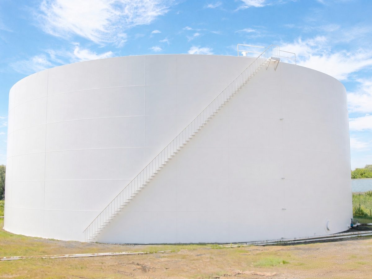 Large white field-erected steel storage tank after exterior coating